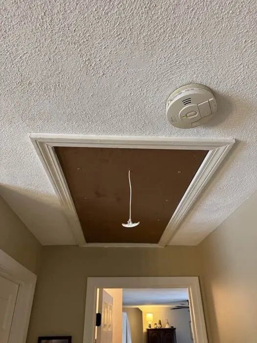 Attic hatch and smoke detector after repair