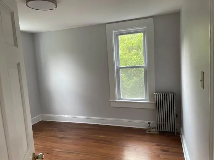 Repainted room with refinished floors after